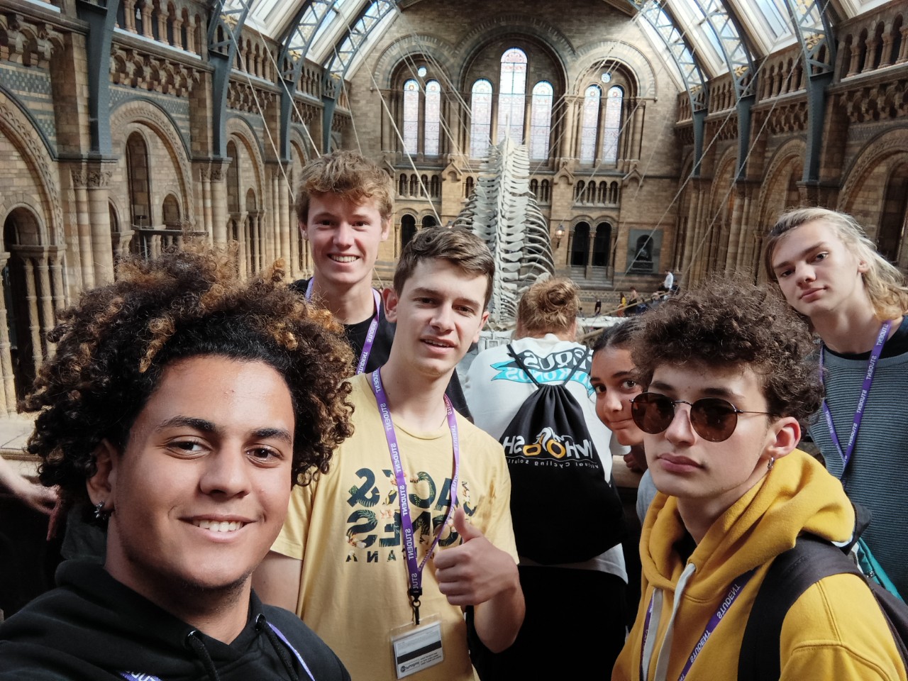 Junior students on a group selfie during a Natural History Museum excursion in London