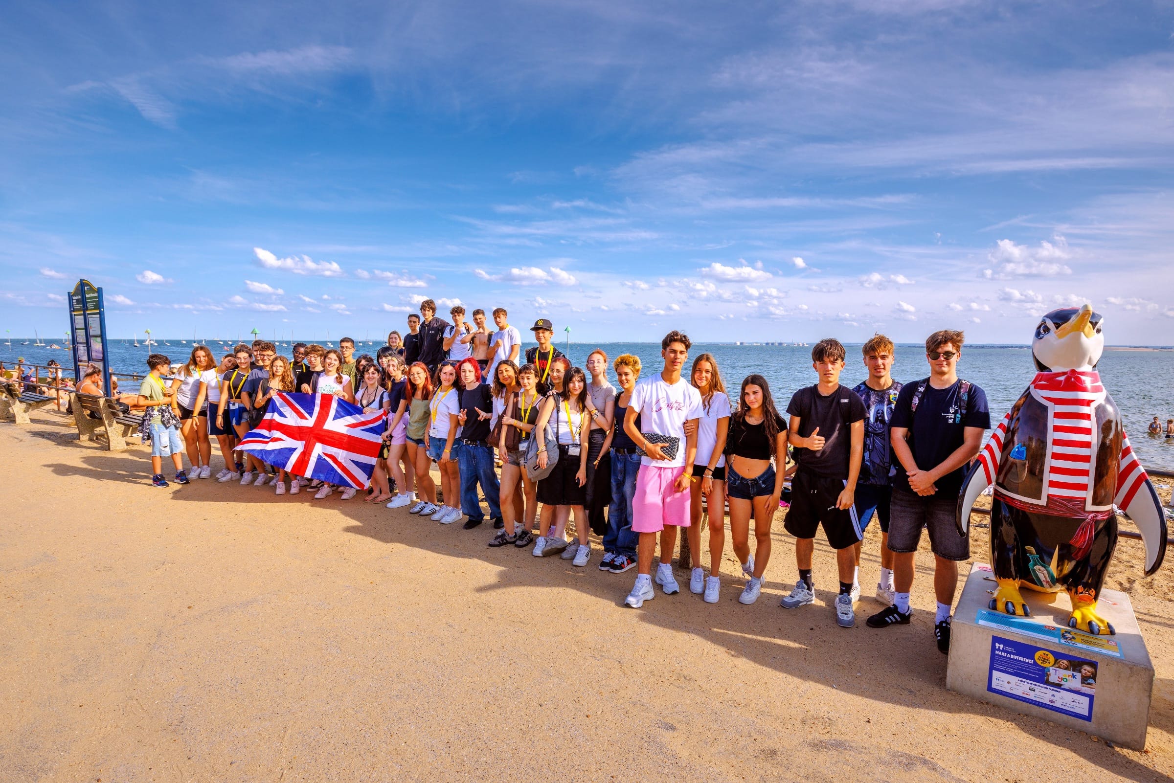 Junior summer camp students posing with a Union Jack flag along Southend-on-Sea's seafront promenade