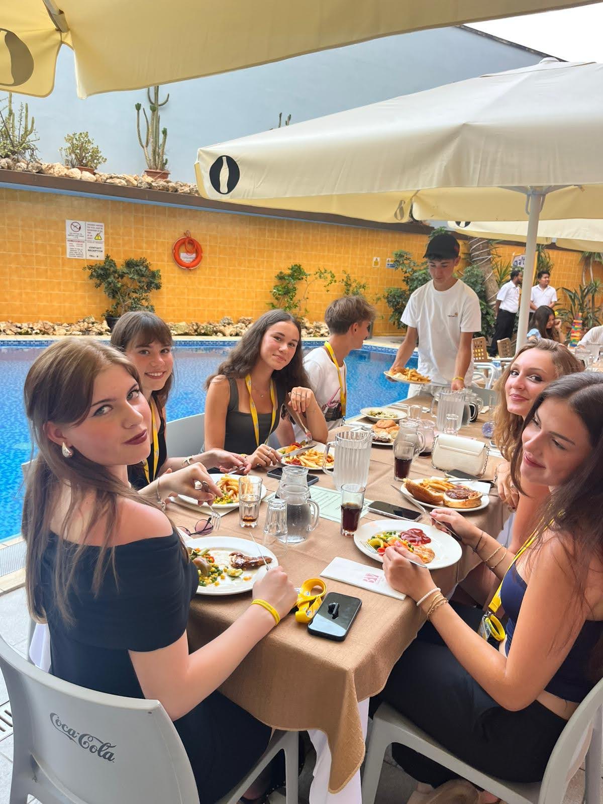 Junior students enjoying a poolside lunch together during their Malta language course