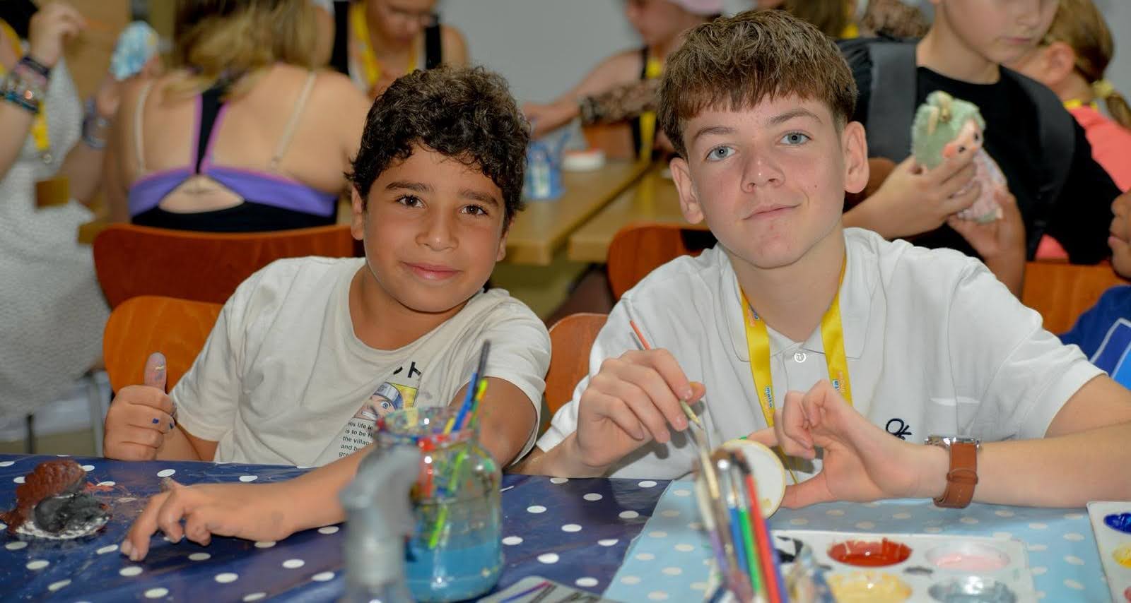Two junior students enjoying a painting activity during their Malta language camp