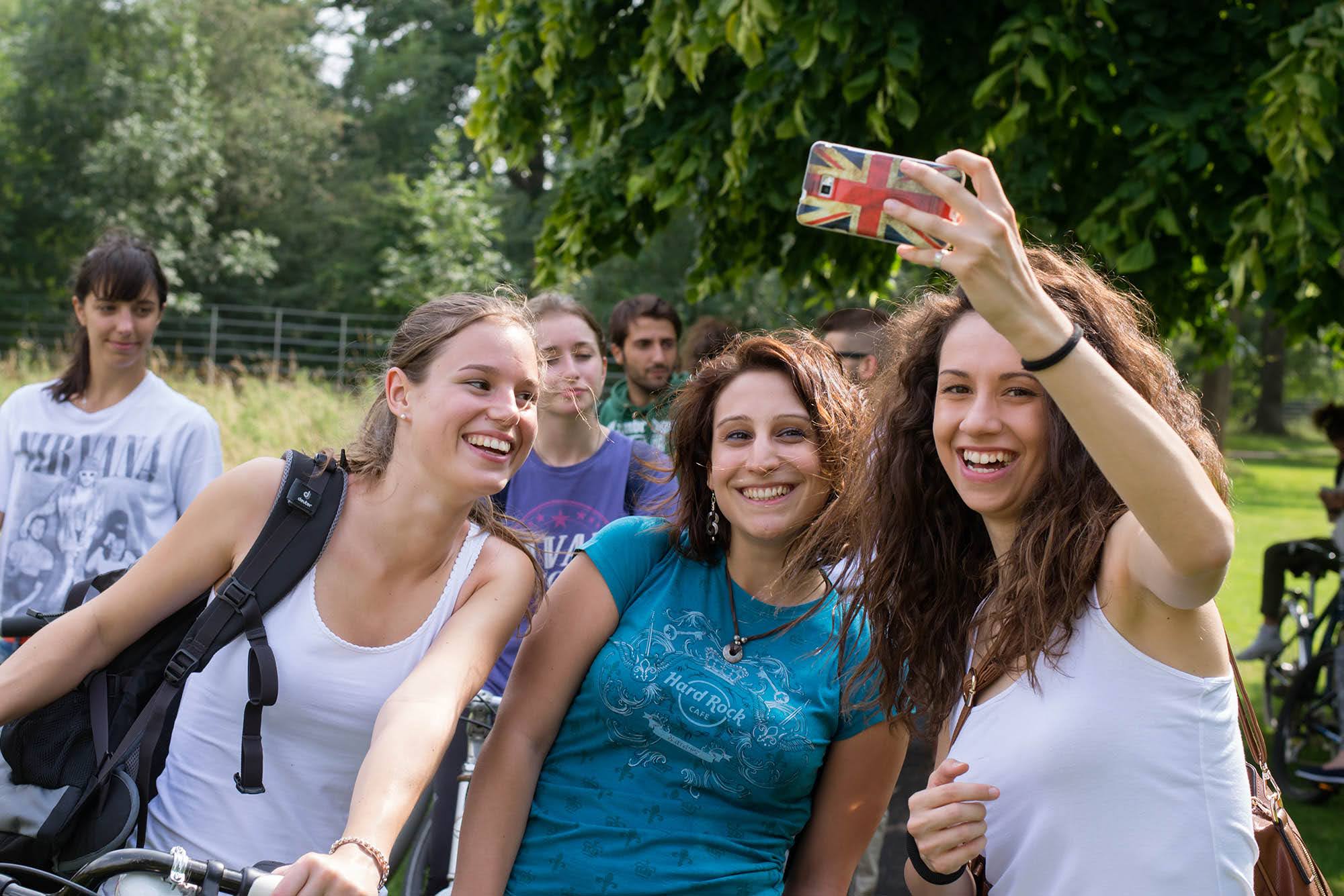 Group of smiling adult students taking a selfie during a cycling activity in Ireland