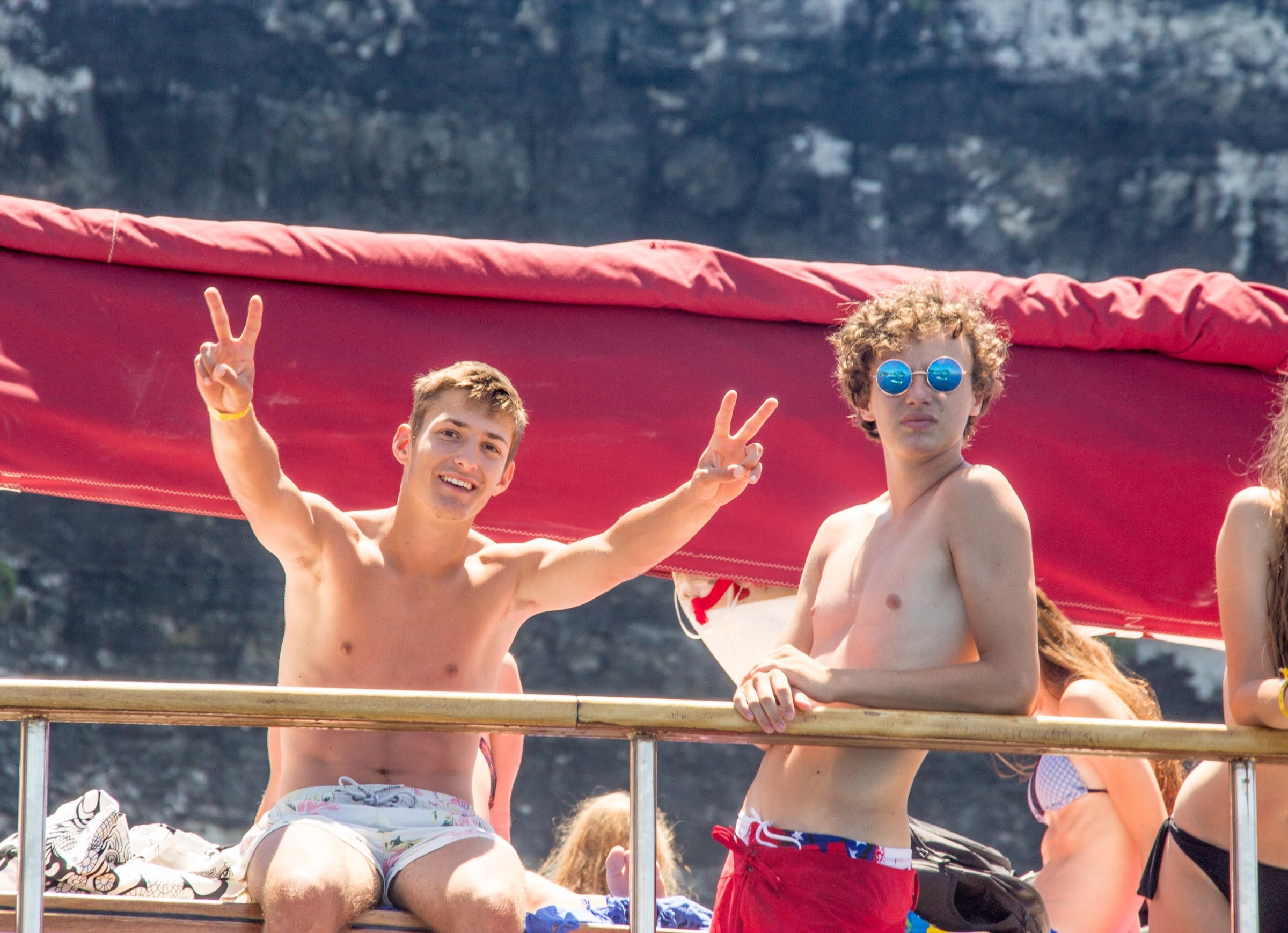 Junior students flashing peace signs on a boat trip during their Malta language course