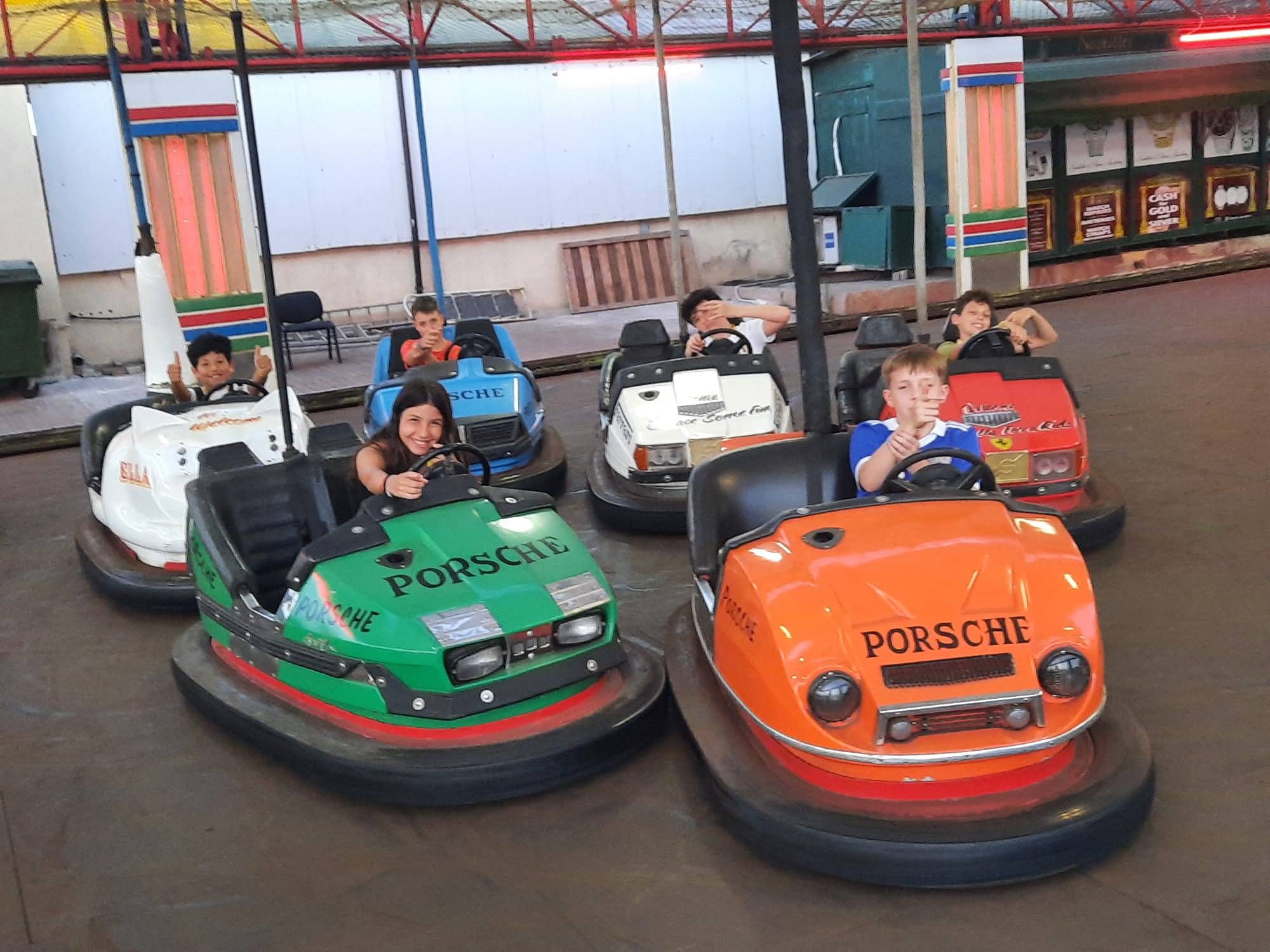 Junior students enjoying bumper cars at a Malta arcade during a language course excursion