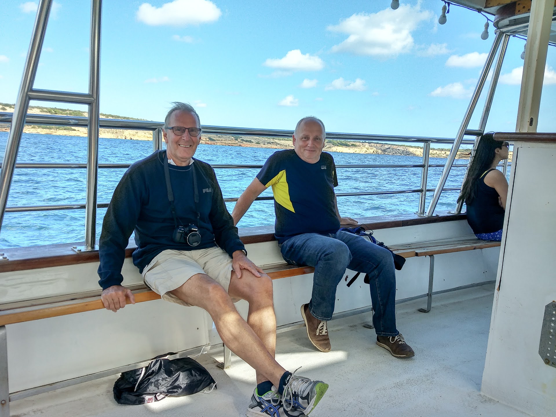 Adult students smiling on a boat trip along Malta's coastline