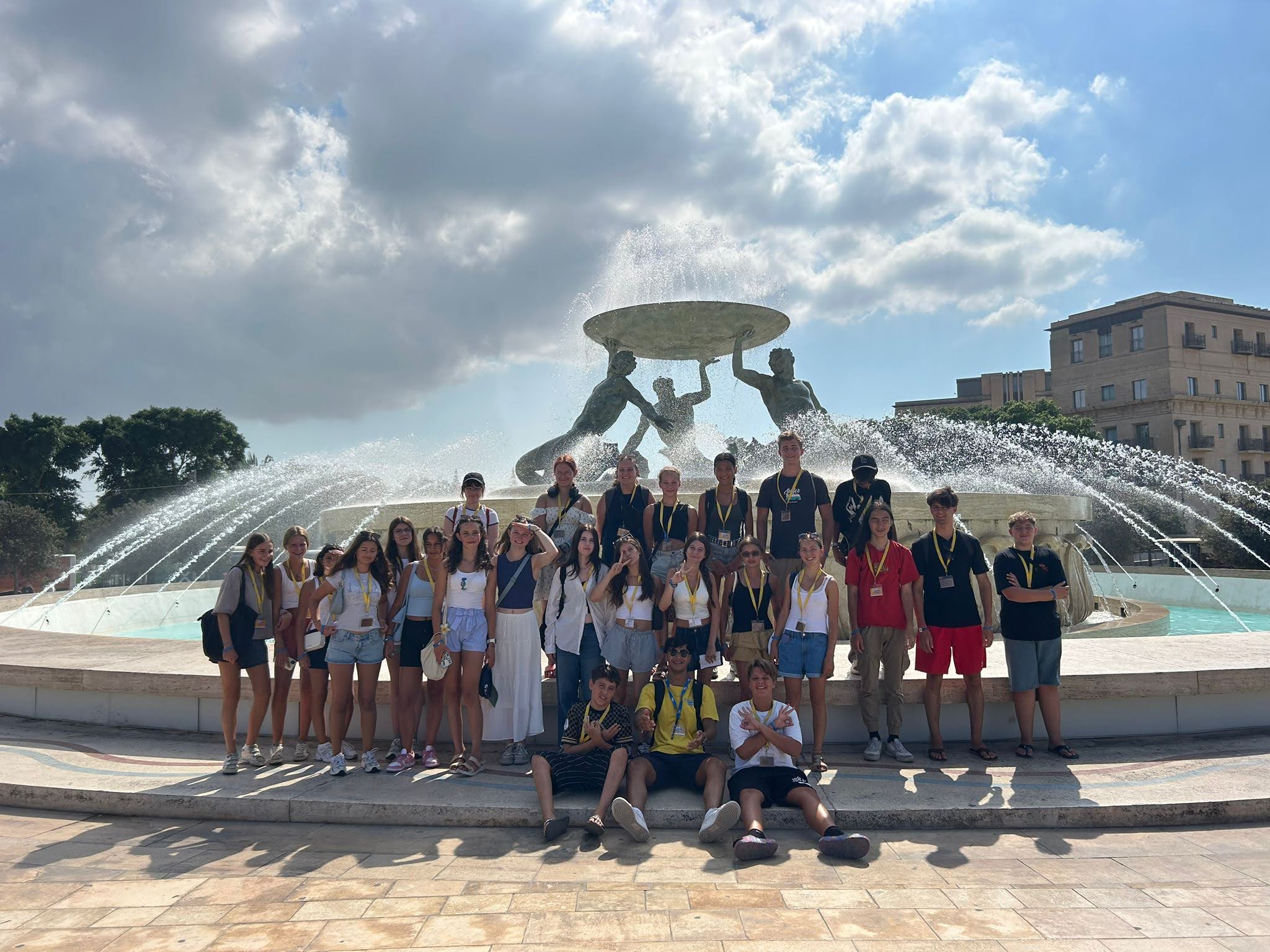 Junior students group photo at the Triton Fountain in Valletta, Malta during a language course excursion