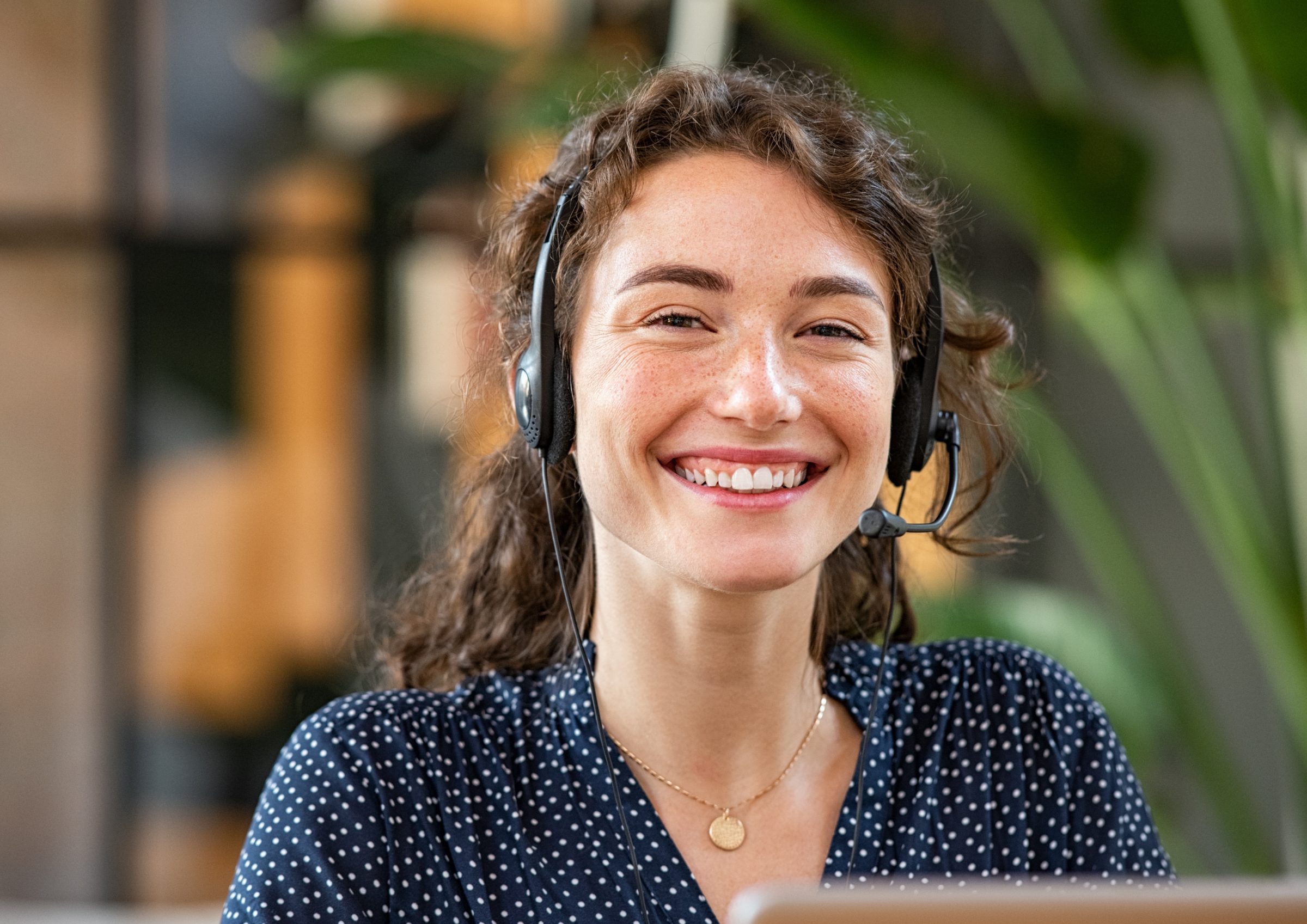 Smiling EduLeap advisor wearing a headset, ready to guide families through study abroad programs