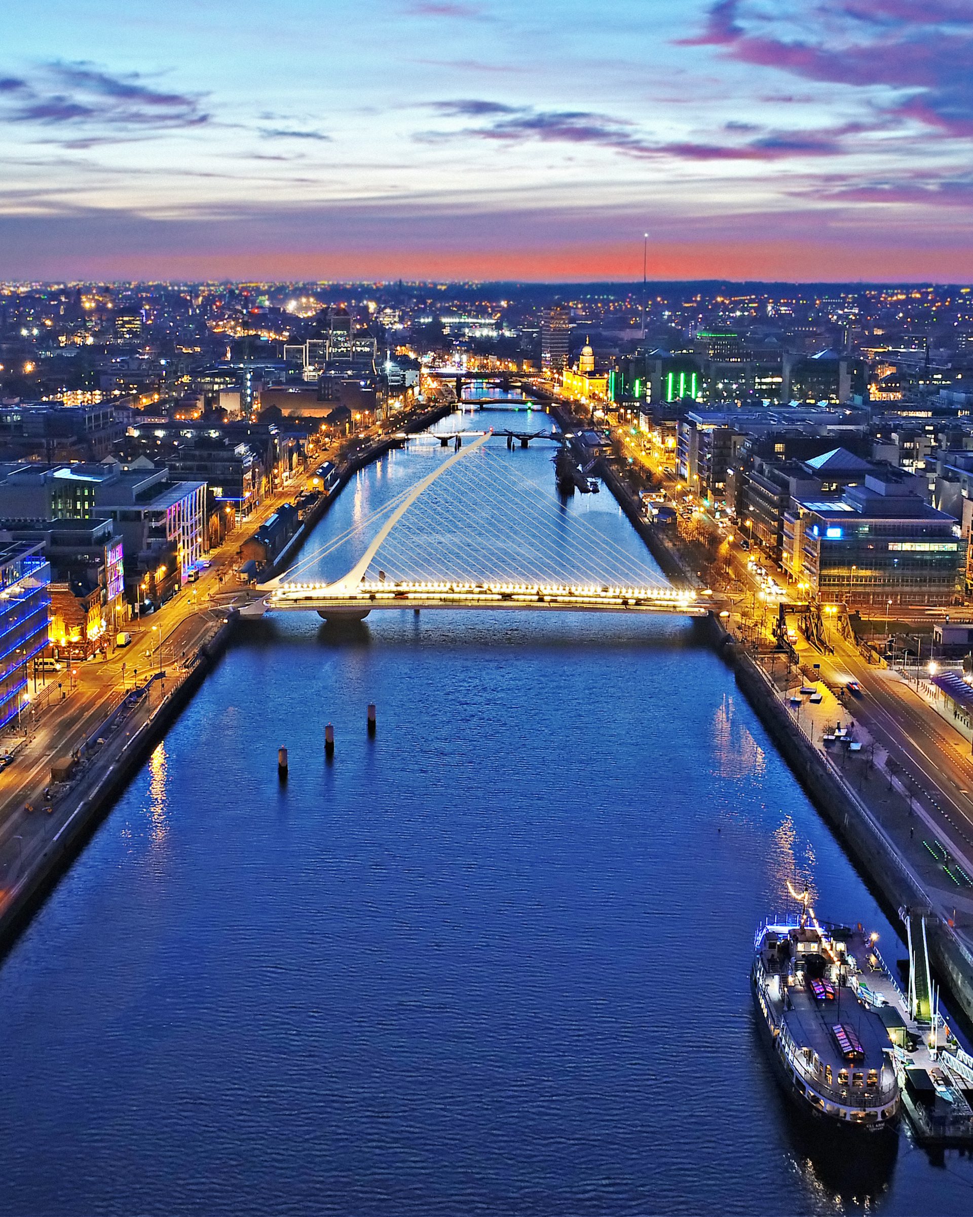 Aerial twilight view of Dublin's Samuel Beckett Bridge over the River Liffey in Ireland